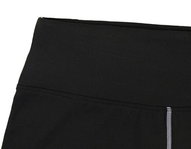 Close-up of black high waist insulated yoga leggings for women, SF1952 model, highlighting the elastic waistband and durable stitching.